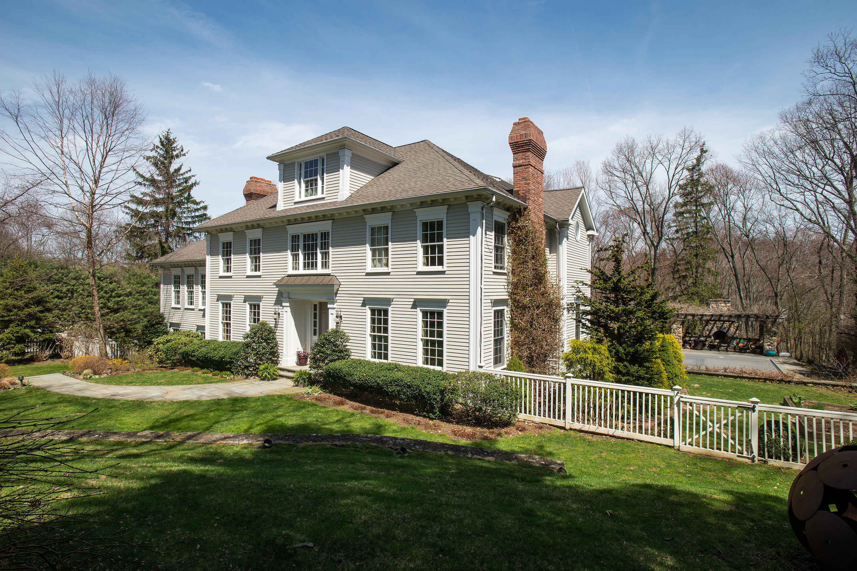276 White Oak Shade Road New Canaan, CT 06840 - Photo 3 of 36 a front view of a house with a garden