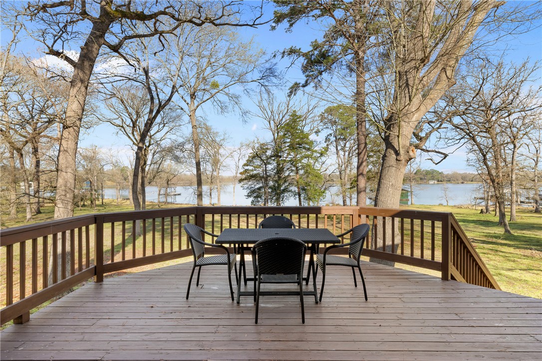 9249 Clyde Acord Road Franklin, TX 77856 - Photo 6 of 23 Wooden terrace featuring outdoor dining area and a water view