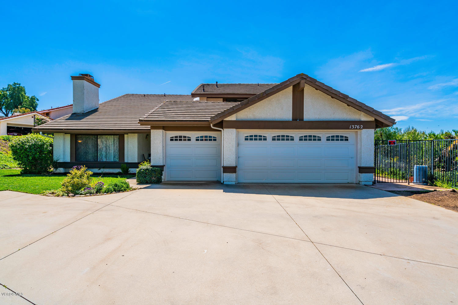 13762 Gunsmoke Road Moorpark, CA 93021 - Photo 1 of 36 a front view of a house with a yard and garage