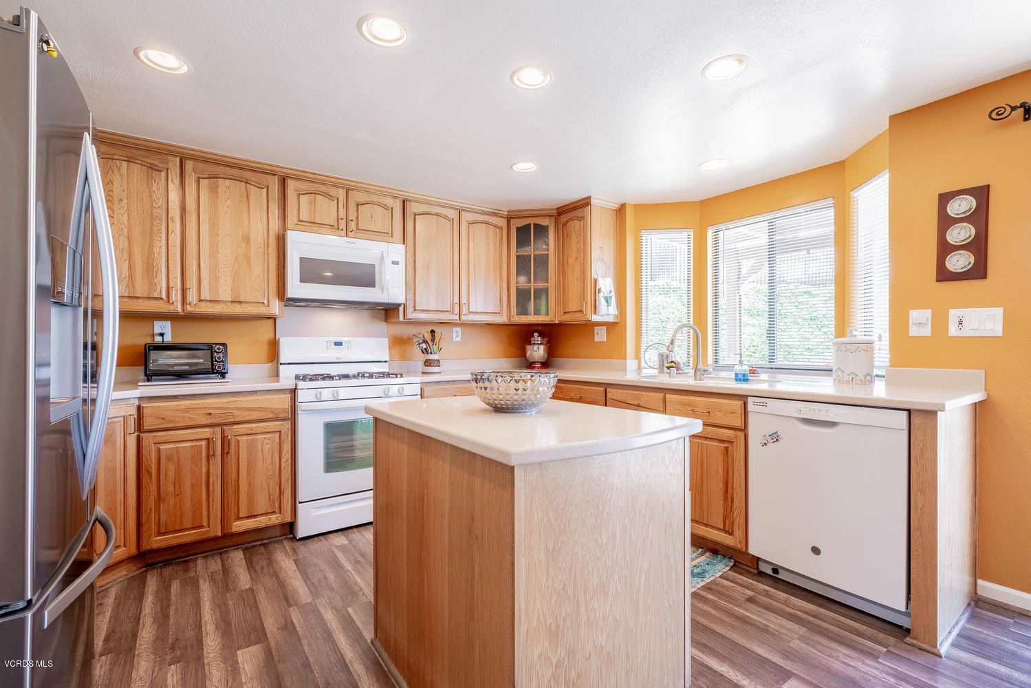 13762 Gunsmoke Road Moorpark, CA 93021 - Photo 11 of 36 a kitchen with stainless steel appliances granite countertop a sink a stove a refrigerator cabinets and a window