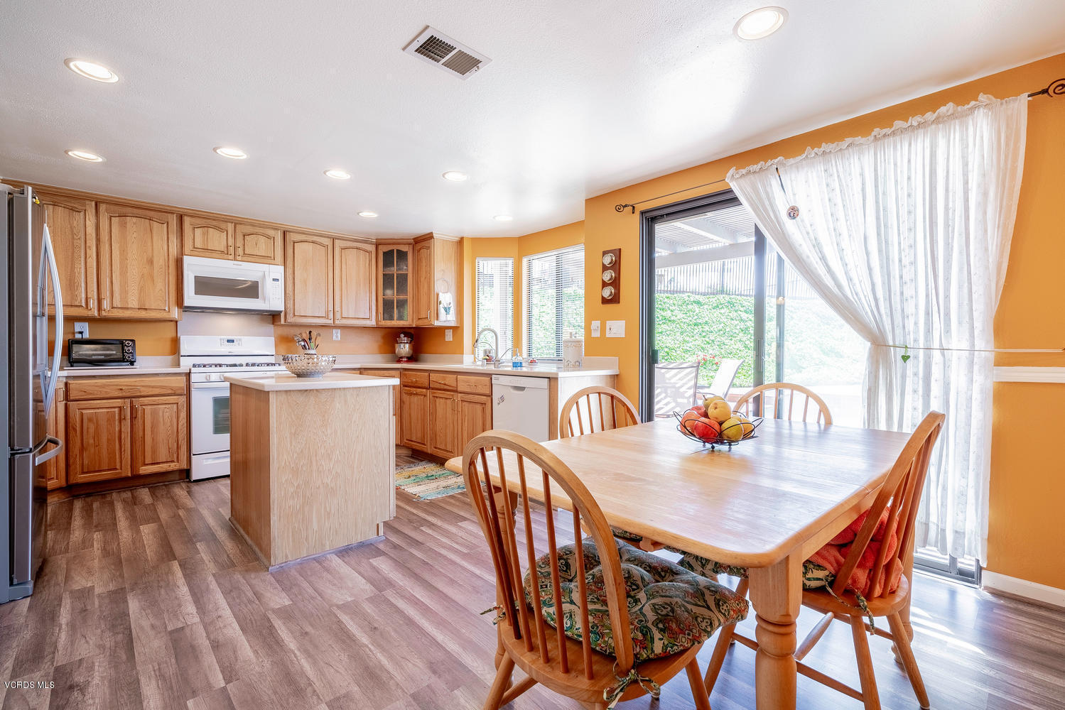 13762 Gunsmoke Road Moorpark, CA 93021 - Photo 3 of 36 a kitchen with stainless steel appliances granite countertop a stove a refrigerator a kitchen island a table and chairs