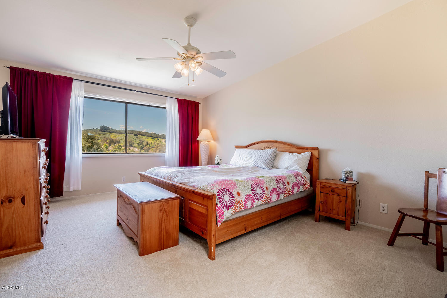 13762 Gunsmoke Road Moorpark, CA 93021 - Photo 22 of 36 a bedroom with a bed and a chandelier