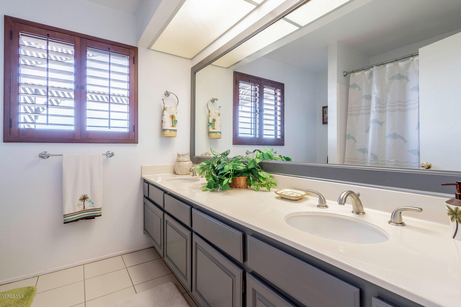 13762 Gunsmoke Road Moorpark, CA 93021 - Photo 28 of 36 a bathroom with a granite countertop sink and a mirror