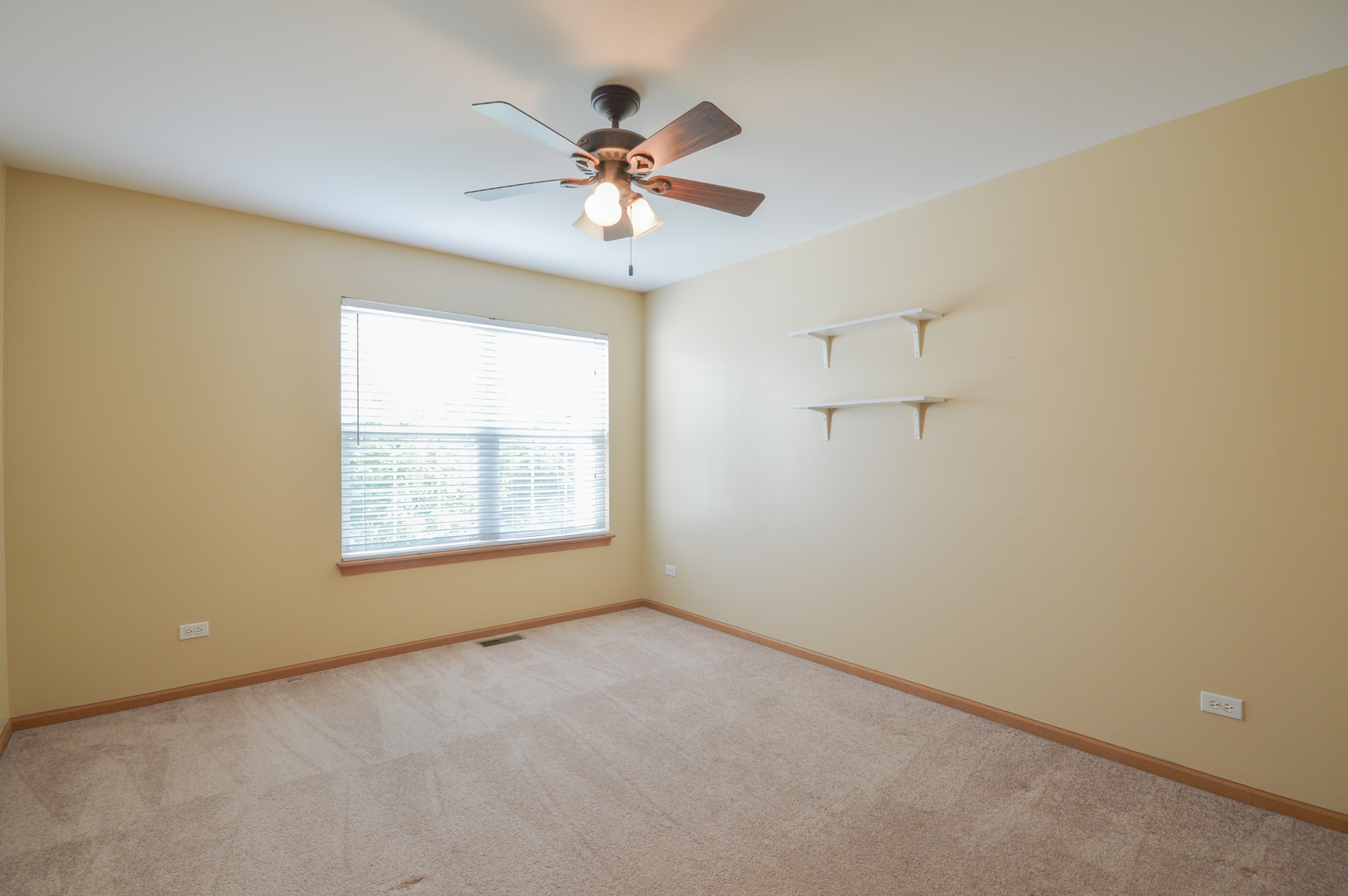 776 River Walk Drive Wheeling, IL 60090 - Photo 15 of 25 an empty room with a chandelier fan and windows