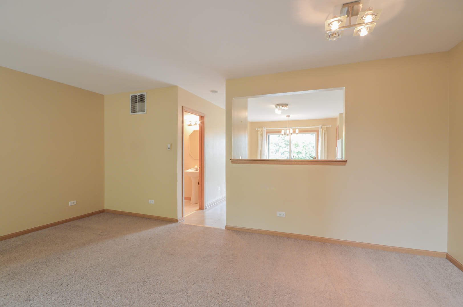 776 River Walk Drive Wheeling, IL 60090 - Photo 3 of 25 an empty room with a window and a mirror