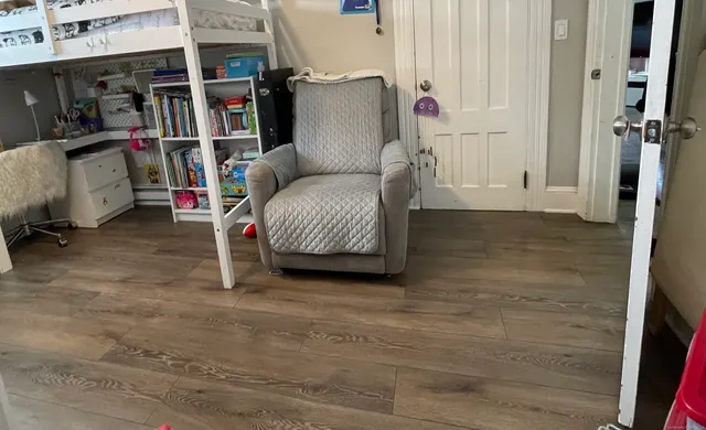 a living room with furniture and a book shelf