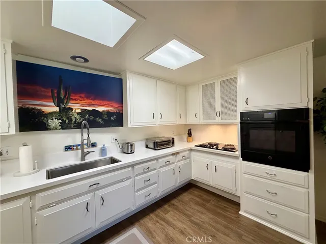 a kitchen with appliances cabinets and a sink