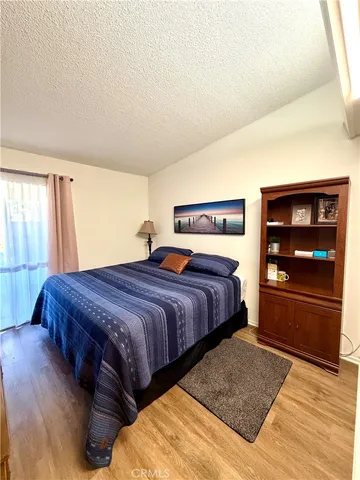 a bedroom with bed and cabinets