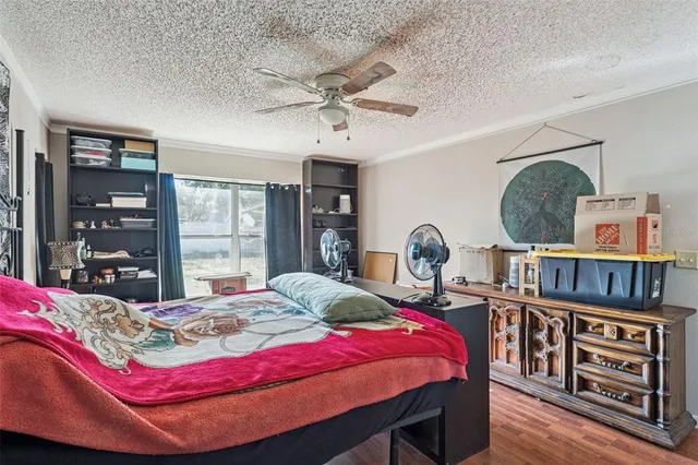 a bedroom with a bed a dresser and book shelf