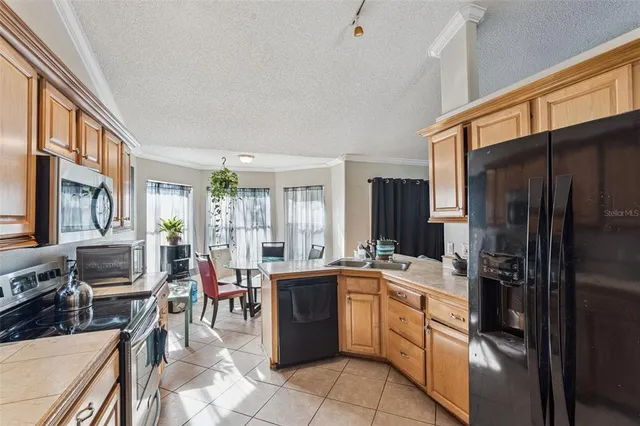 a kitchen with a sink refrigerator and cabinets