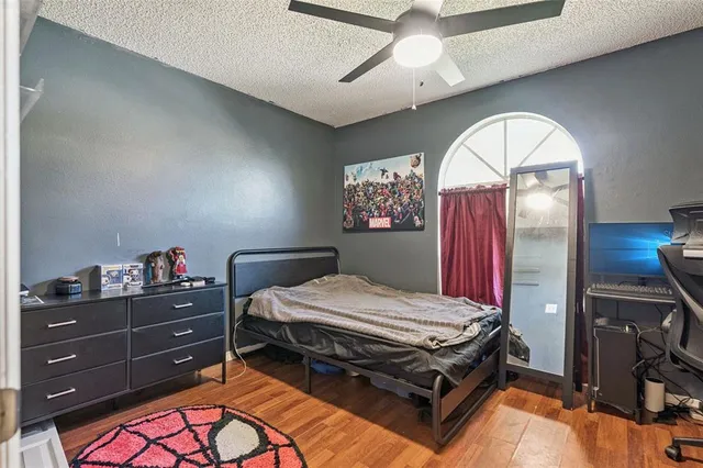 a bed room with a bed and a chandelier