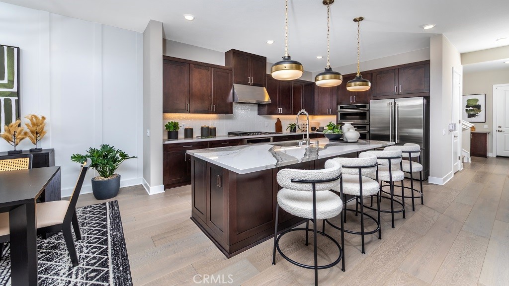 91 Interval Irvine, CA 92618 - Photo 2 of 14 an open kitchen with granite countertop a stove a sink a dining table and chairs