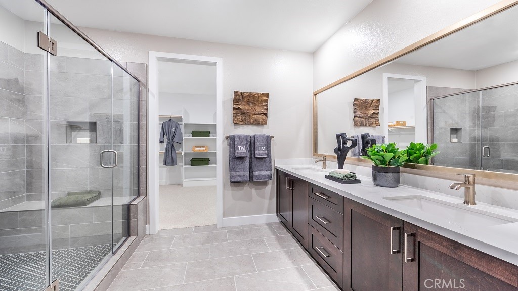 91 Interval Irvine, CA 92618 - Photo 5 of 14 a bathroom with a double vanity sink a large mirror a shower and a bathtub