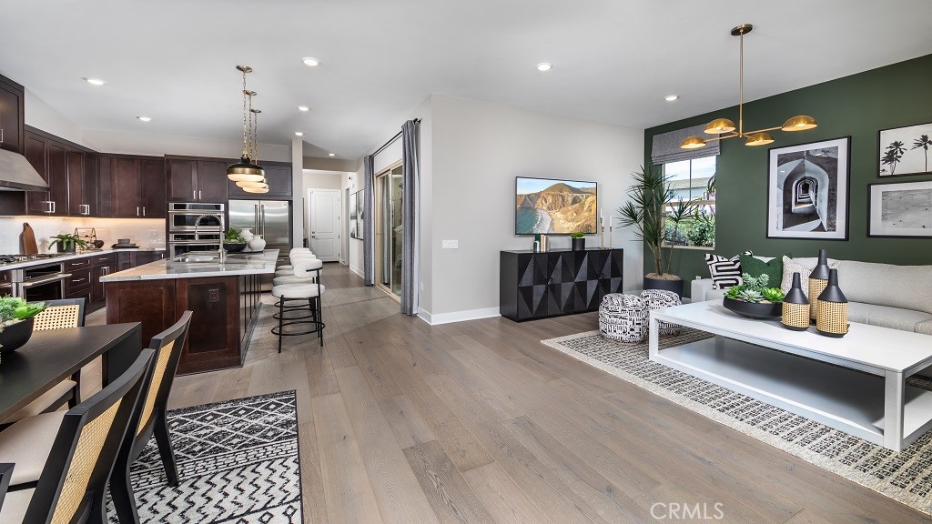 91 Interval Irvine, CA 92618 - Photo 7 of 14 a living room with furniture kitchen view and a wooden floor
