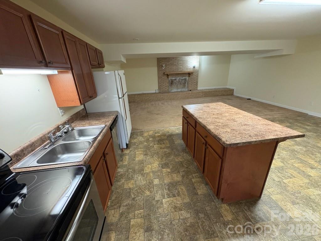 2610 Taylor Road Shelby, NC 28152 - Photo 33 of 47 a kitchen with kitchen island a stove top oven and sink