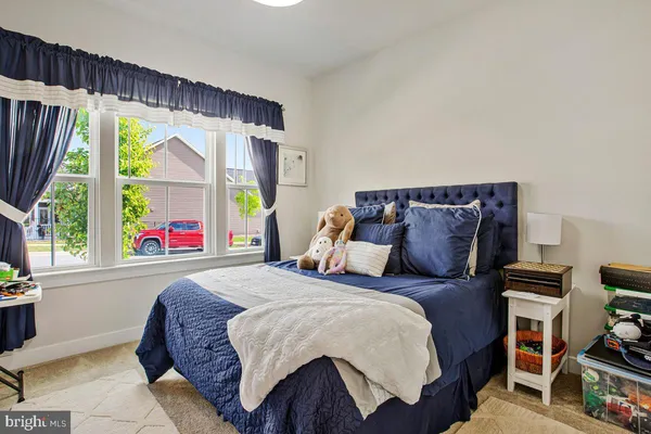a bedroom with a bed and a large window