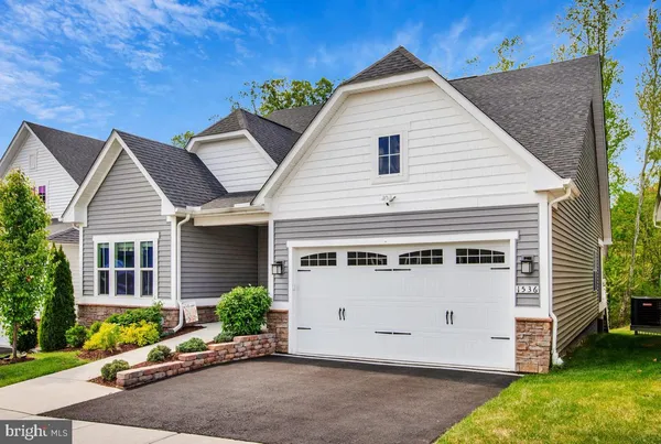 a view of a house with a yard and garage