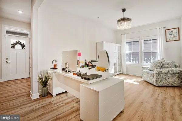 a work room with furniture and a wooden floor