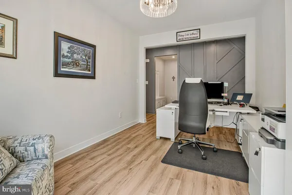 a view of workspace with wooden floor and lounge chair