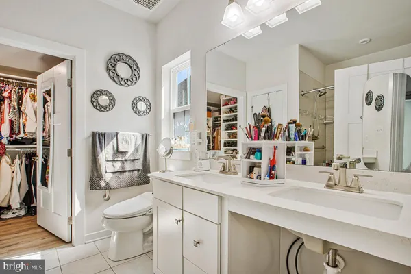 a bathroom with a sink mirror vanity and toilet