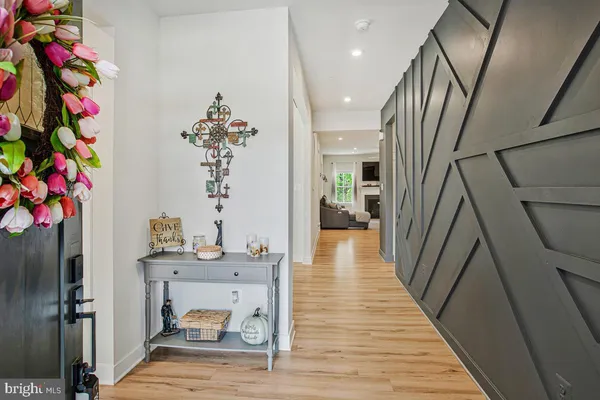 a view of a hallway with wooden floor and entryway