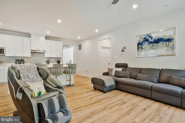 a living room with furniture and kitchen view