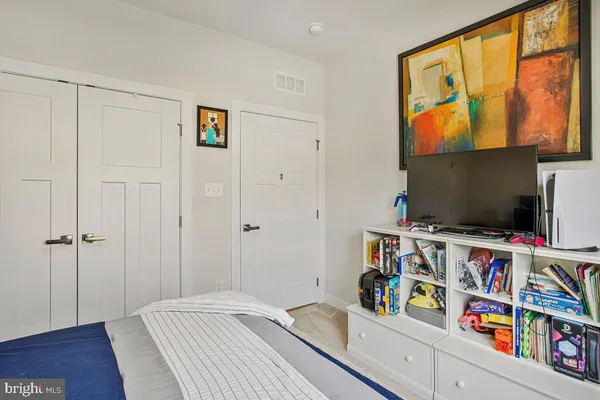 a bedroom with furniture and a book shelf
