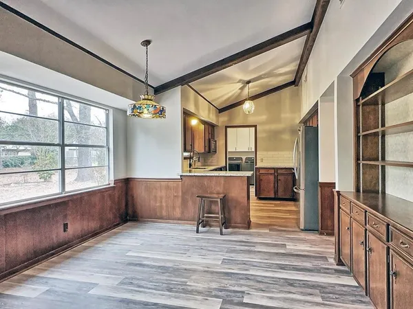 a view of a kitchen with a refrigerator and windows
