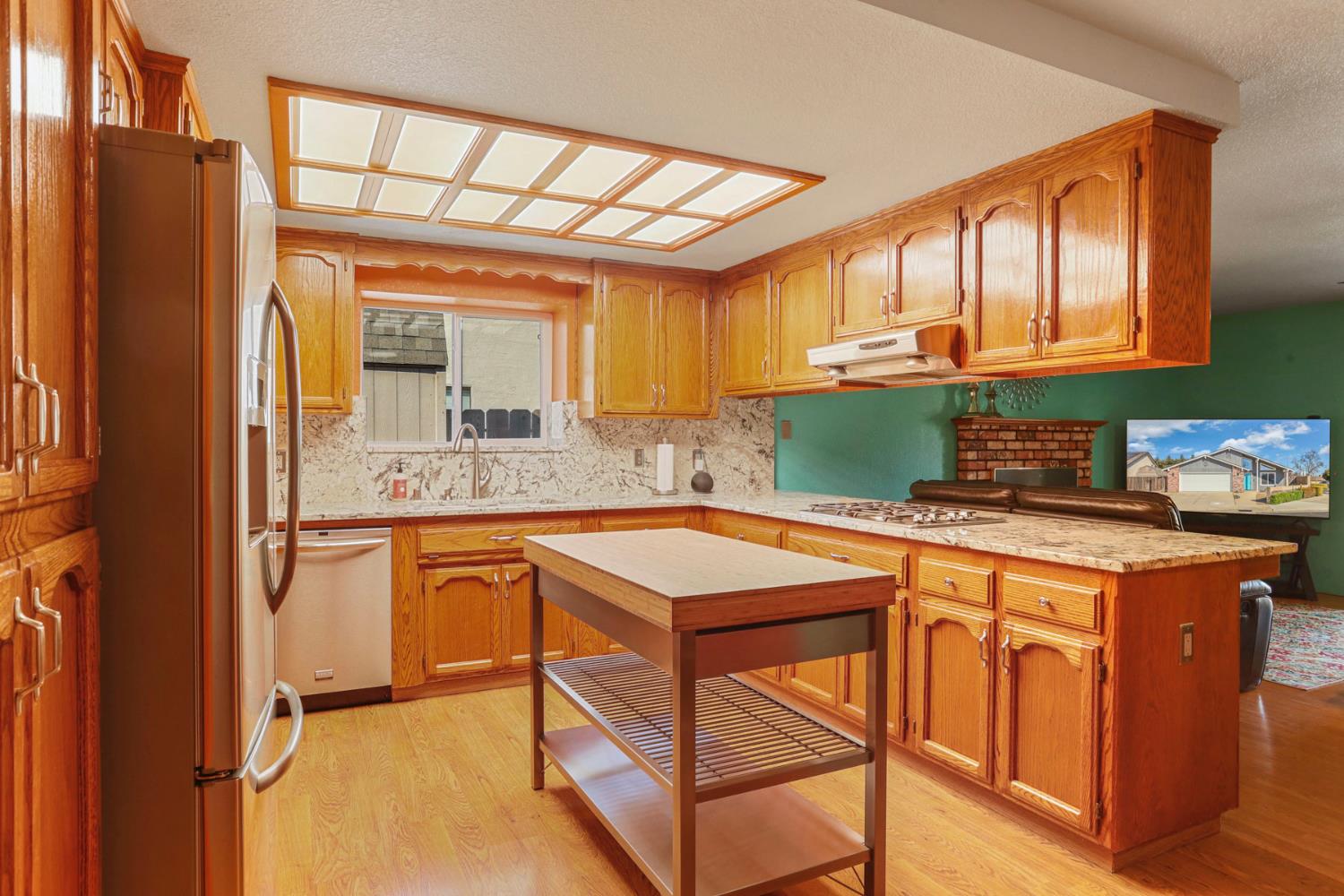 1601 Stanley Drive Ripon, CA 95366 - Photo 11 of 41 a kitchen with stainless steel appliances granite countertop a refrigerator and a sink