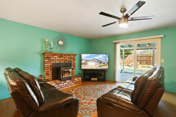 a living room with furniture a window and a flat screen tv