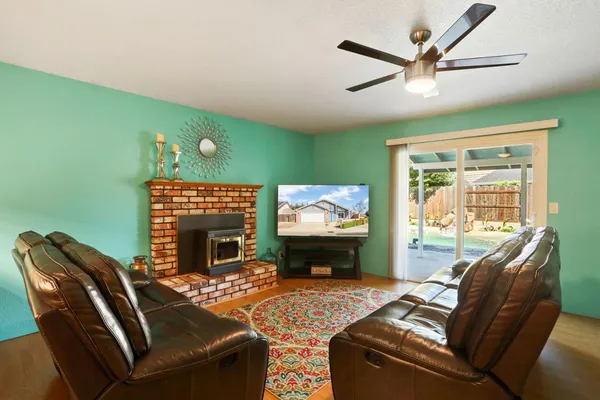 a living room with furniture a fireplace and a flat screen tv
