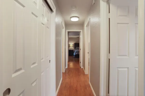 a view of a hallway with wooden floor