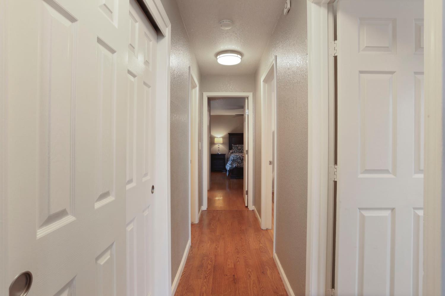 1601 Stanley Drive Ripon, CA 95366 - Photo 22 of 41 a view of a hallway with wooden floor