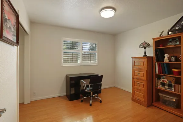 a view of a workspace with furniture and a bookshelf