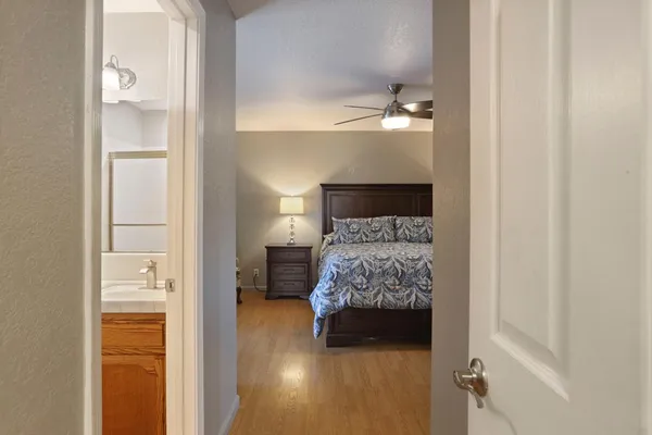 a bedroom with a bed and a chandelier
