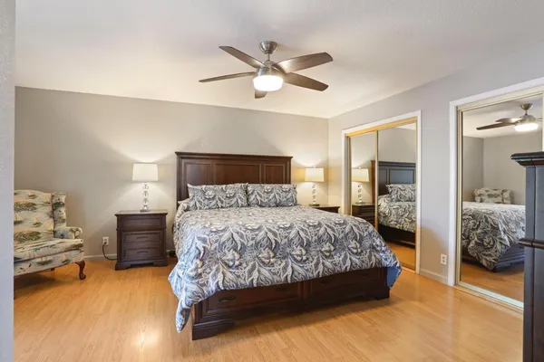 a bedroom with a large bed and a chandelier