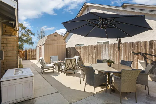 a view of an outdoor sitting area with furniture and umbrella