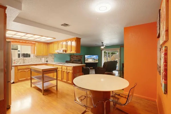 a kitchen with a table chairs and a refrigerator