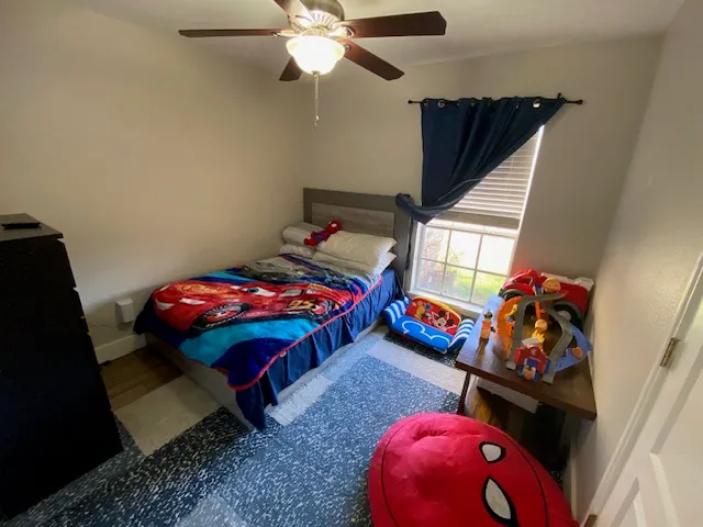 a bedroom with a bed and a baby crib