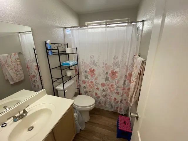 a bathroom with a sink toilet and shower