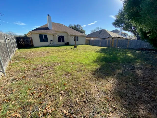 a front view of a house with yard and green space