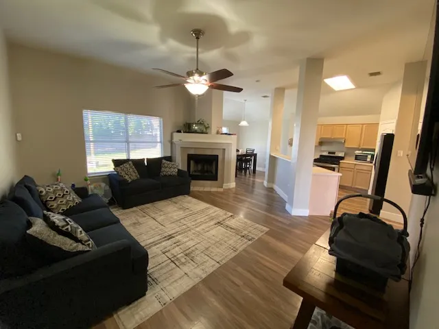 a living room with furniture a fireplace and a chandelier