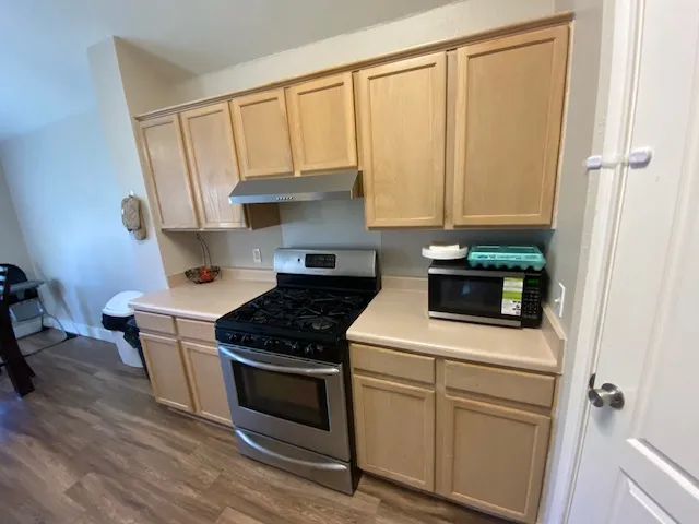a kitchen with a stove and a microwave