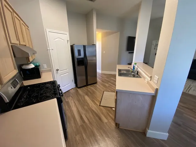 a room with furniture a refrigerator and washer