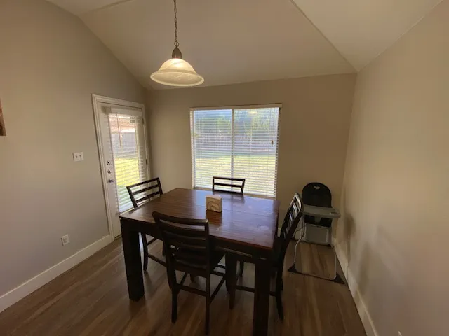 a view of a dining room with furniture and window