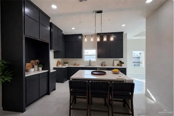 a kitchen with a table chairs sink and microwave