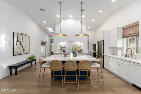 a large kitchen with a table and chairs
