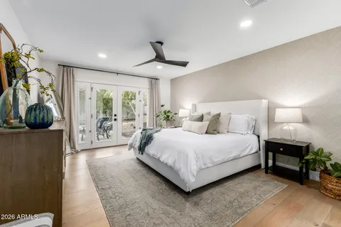 a spacious bedroom with a bed and a chandelier