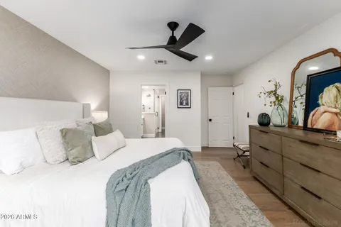 a bed room with a bed and a large mirror
