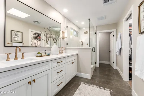 a spacious bathroom with a double vanity sink mirror and double